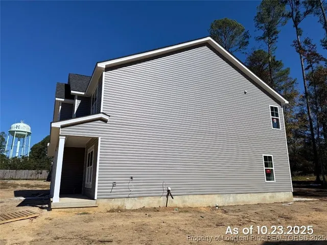a view of a house with a backyard