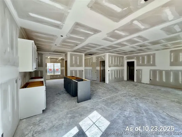 a living room with furniture and a kitchen