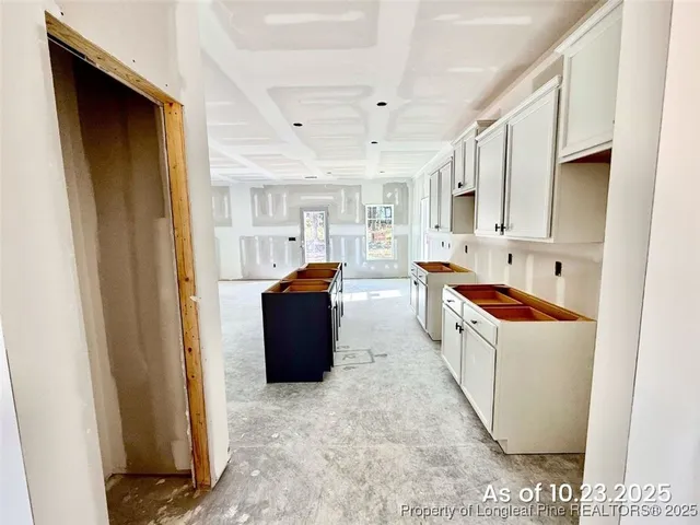 a view of kitchen with stainless steel appliances granite countertop a refrigerator and a sink