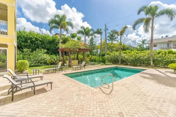 a view of swimming pool with outdoor seating and plants