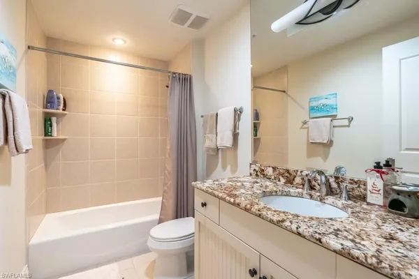 a bedroom with furniture and a wooden floor