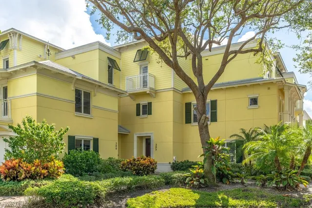 a view of a brick building next to a yard