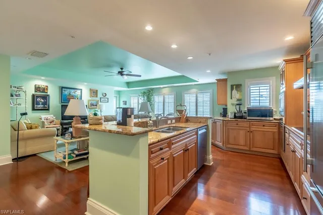 a kitchen with granite countertop white cabinets and stainless steel appliances