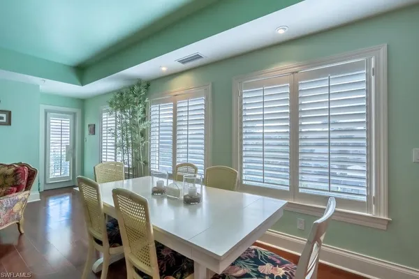 a living room with lots of furniture and view of kitchen