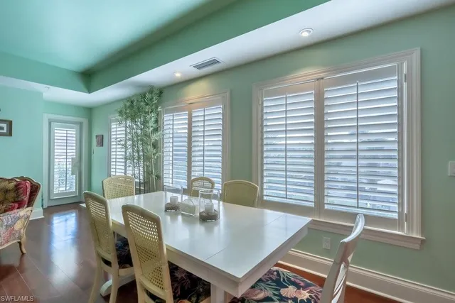 a living room with lots of furniture and view of kitchen