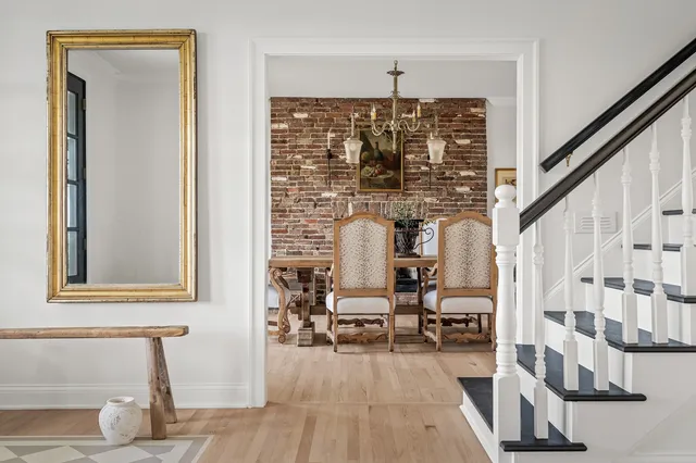 a living room with a fireplace wooden floor and a rug
