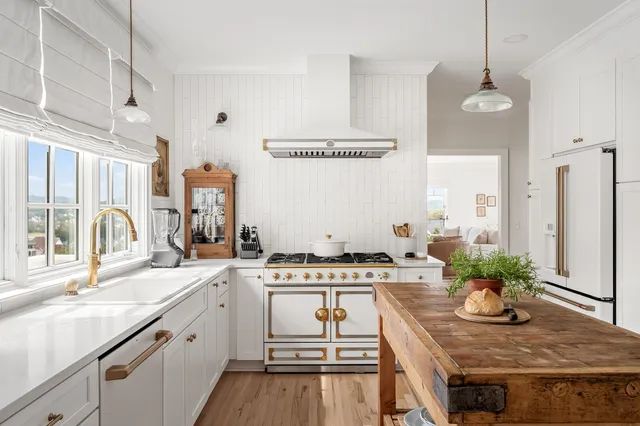 a bathroom with a granite countertop sink a mirror and a bathtub