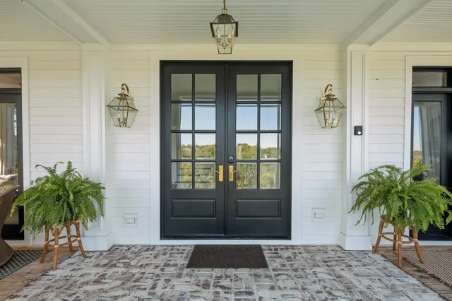 a porch with a potted plant in front of a house