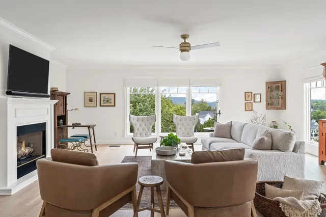 a dining room with furniture a rug and a chandelier