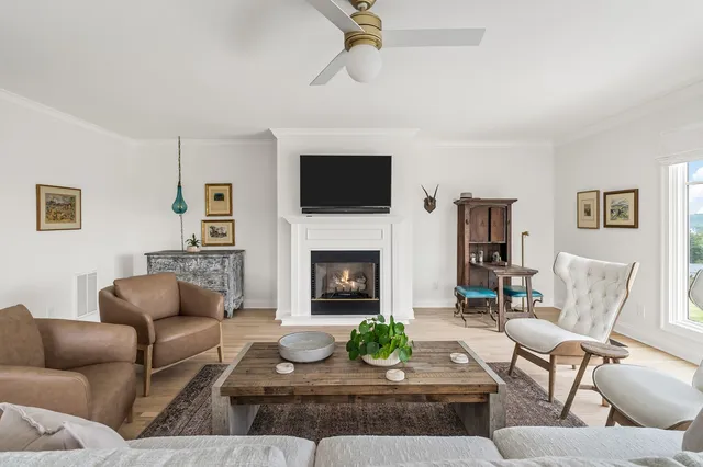 a dining room with furniture a rug and a chandelier