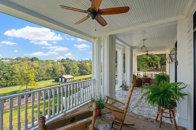 a view of a workspace with furniture and stairs