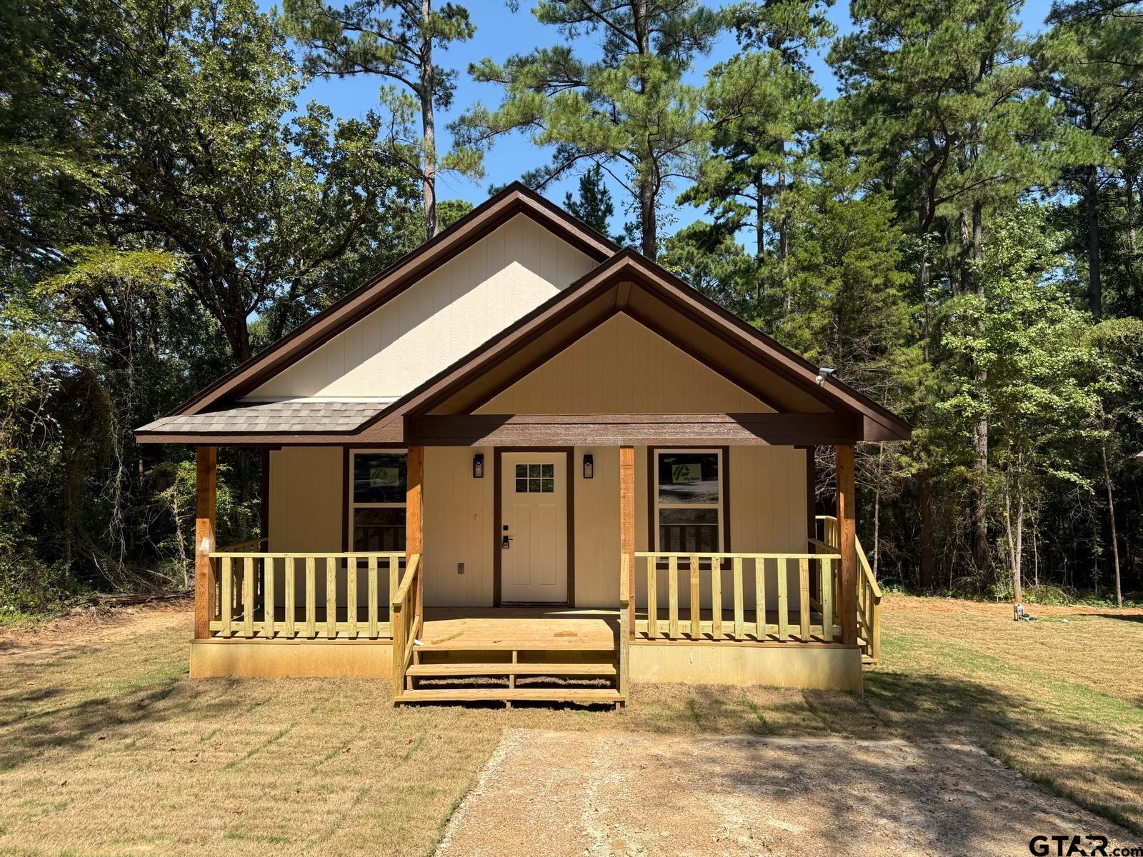 a backyard of a house with a deck and furniture