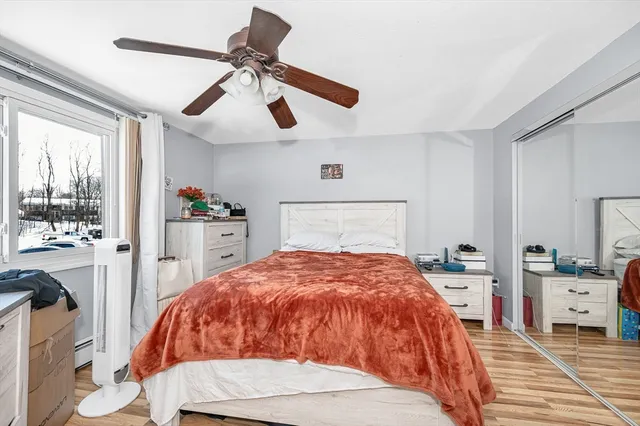 a spacious bedroom with a bed and a chandelier
