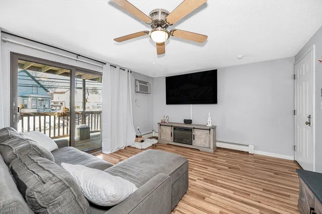 a bedroom with a bed tv and a window