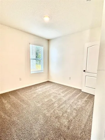 an empty room with a empty space and a window