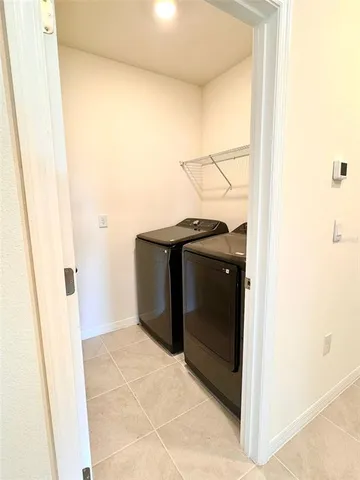 a kitchen with granite countertop a sink and a white cabinets