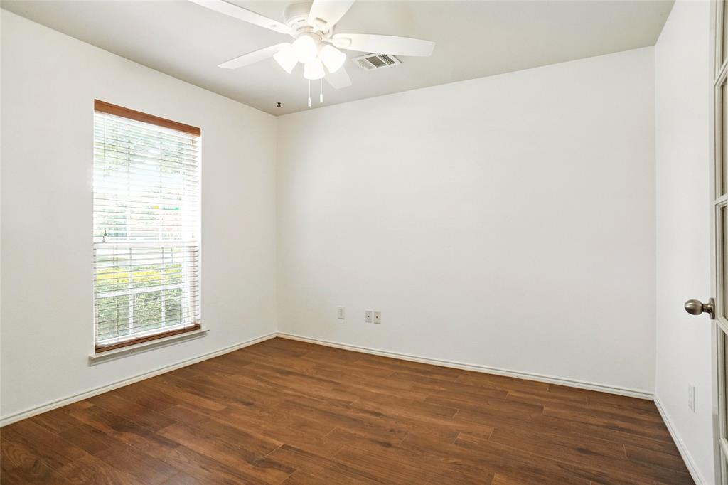 9907 Divine Court Frisco, TX 75033 - Photo 13 of 31 Empty room with dark wood-style flooring and a ceiling fan
