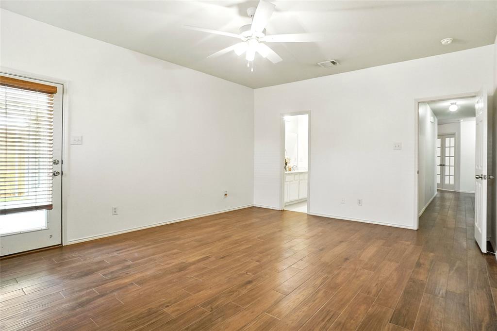 9907 Divine Court Frisco, TX 75033 - Photo 15 of 31 Empty room featuring dark wood-type flooring and a ceiling fan