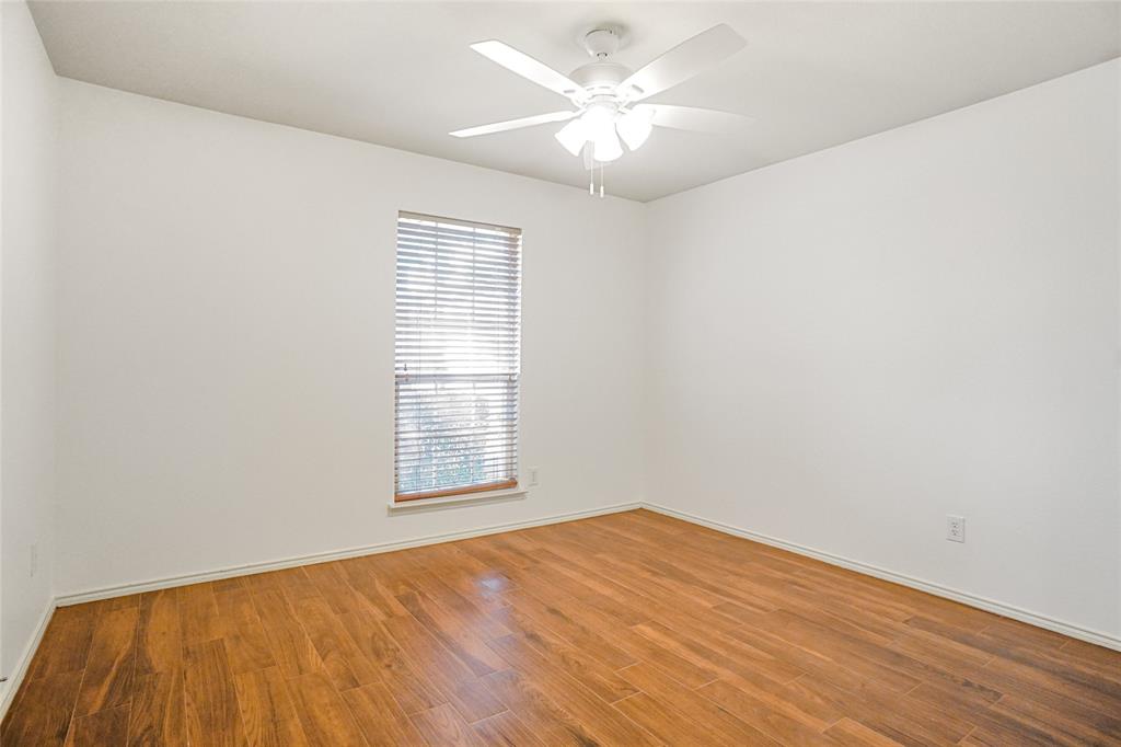 9907 Divine Court Frisco, TX 75033 - Photo 21 of 31 Empty room with light wood-style floors and a ceiling fan