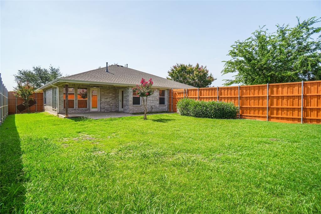 9907 Divine Court Frisco, TX 75033 - Photo 25 of 31 Rear view of property with brick siding, a fenced backyard, a patio, and roof with shingles