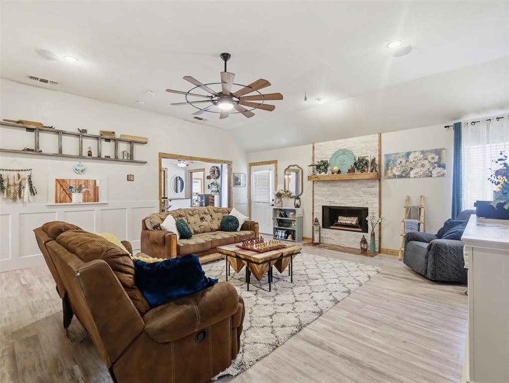 3823 State Highway Bonham, TX 75418 - Photo 26 of 37 a living room with furniture a fireplace and a chandelier