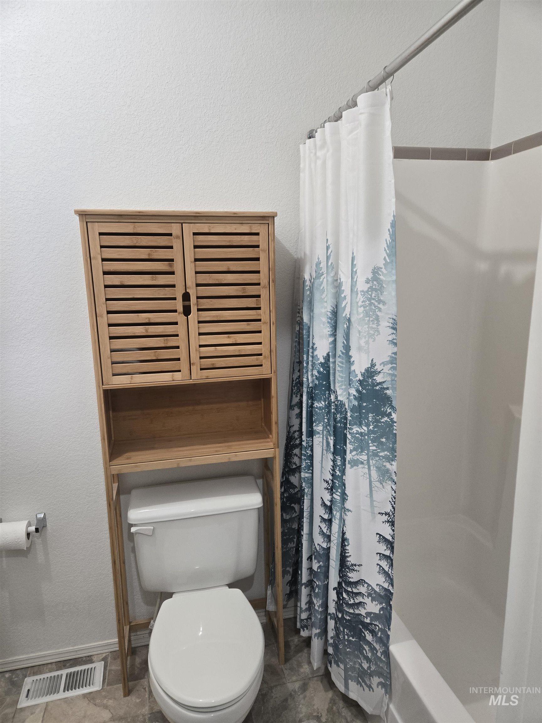 135 Harrisburg Road Kamiah, ID 83536 - Photo 11 of 30 Full bathroom with a textured wall and shower / bath combination with curtain