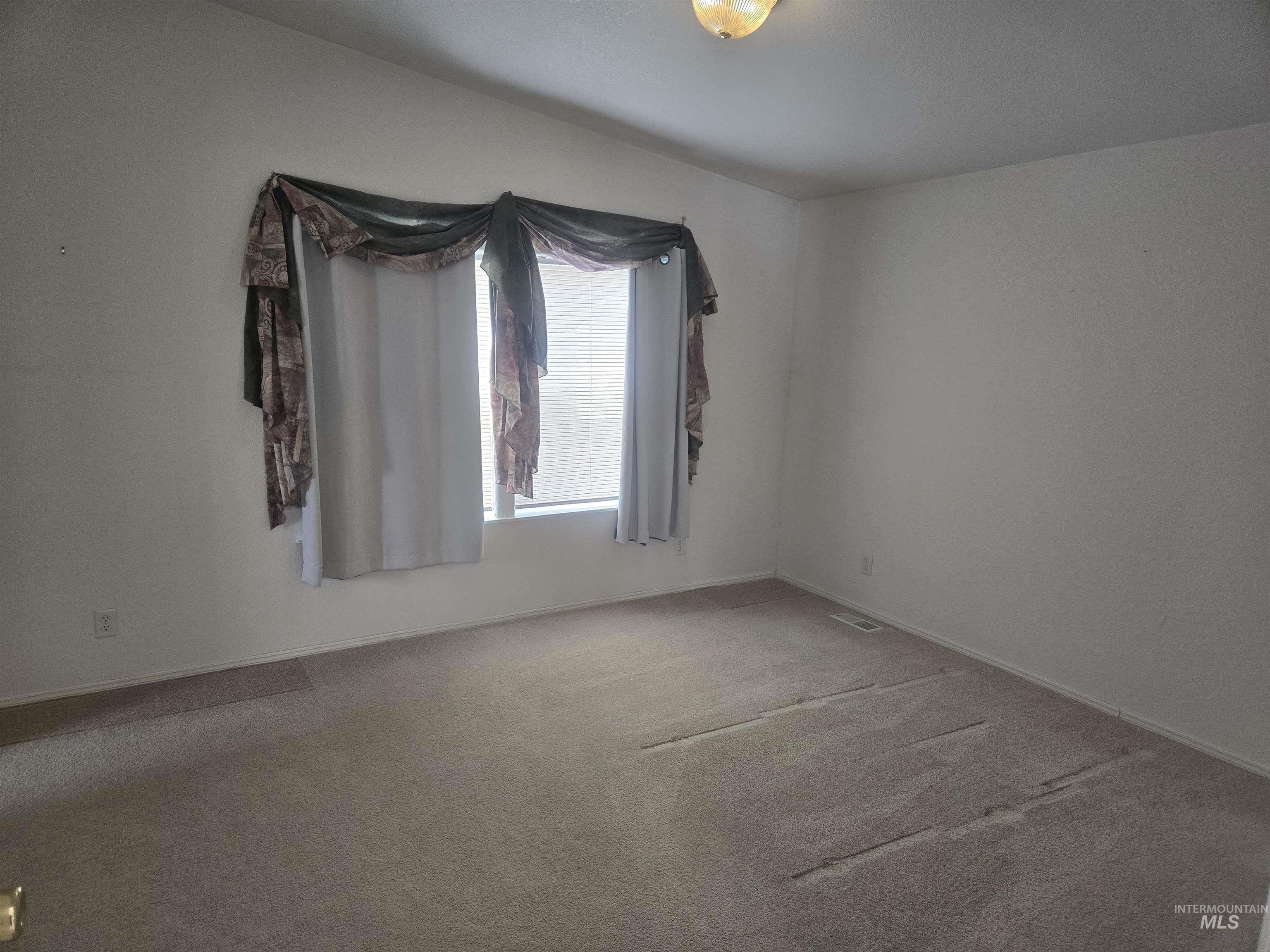 135 Harrisburg Road Kamiah, ID 83536 - Photo 12 of 30 Empty room featuring carpet flooring and baseboards