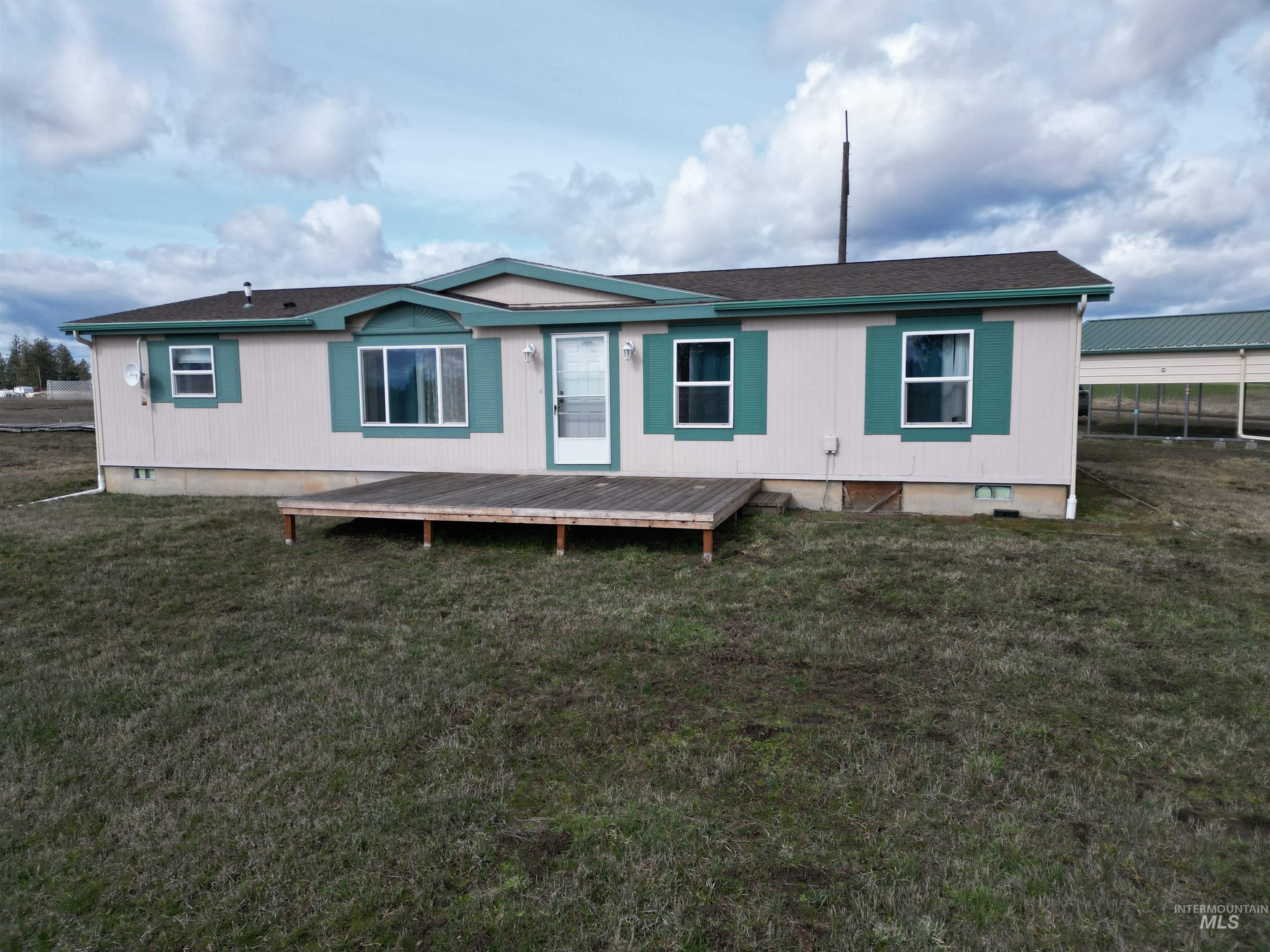 135 Harrisburg Road Kamiah, ID 83536 - Photo 17 of 30 Rear view of property with crawl space, a wooden deck, and a yard