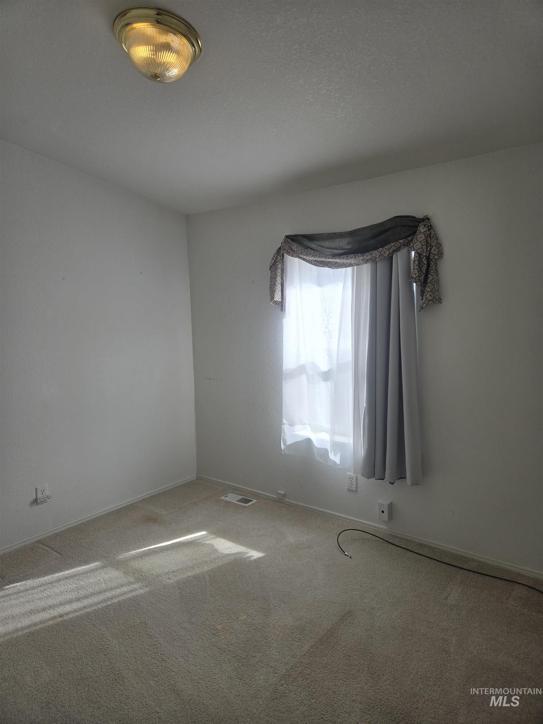 135 Harrisburg Road Kamiah, ID 83536 - Photo 8 of 30 Empty room with carpet and baseboards