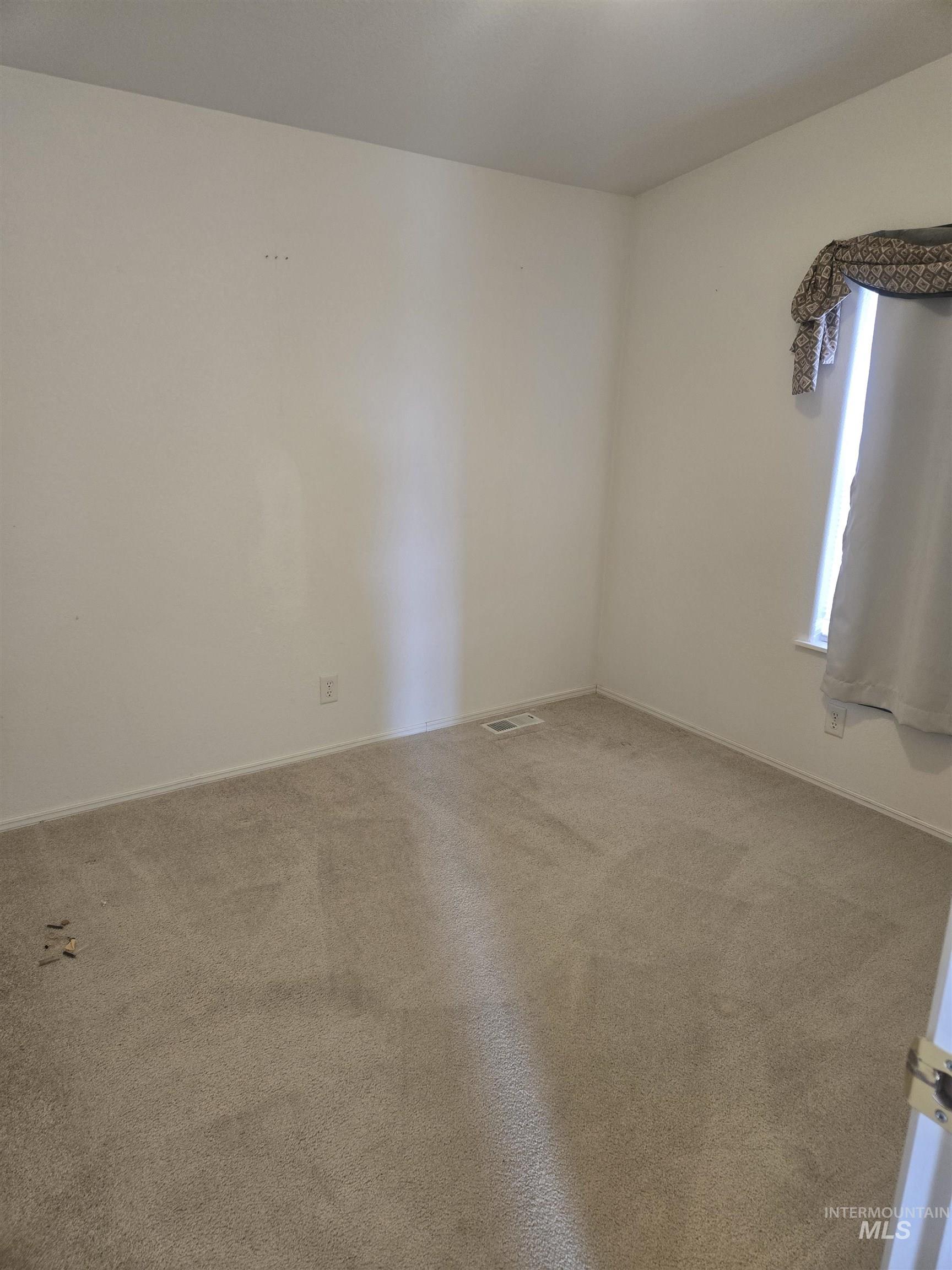 135 Harrisburg Road Kamiah, ID 83536 - Photo 9 of 30 Spare room featuring carpet floors and baseboards