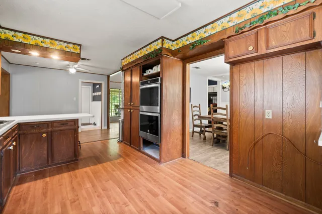 a view of a livingroom with wooden floor and a ceiling fan