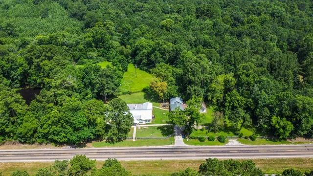 an aerial view of a house with a yard