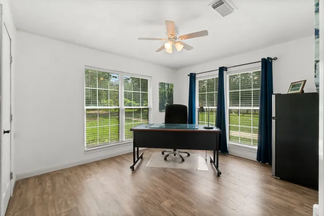 a view of a workspace with furniture and a window