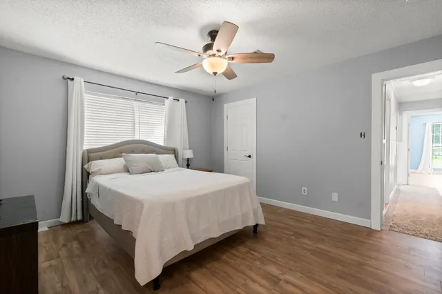 a bedroom with a large bed and a large window