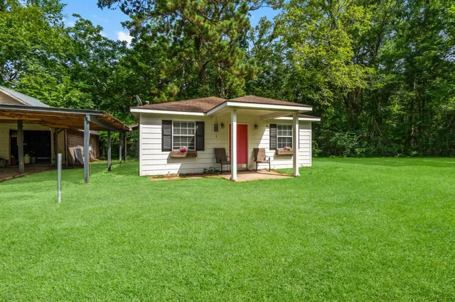 a view of a livingroom with a furniture hardwood floor and a ceiling fan