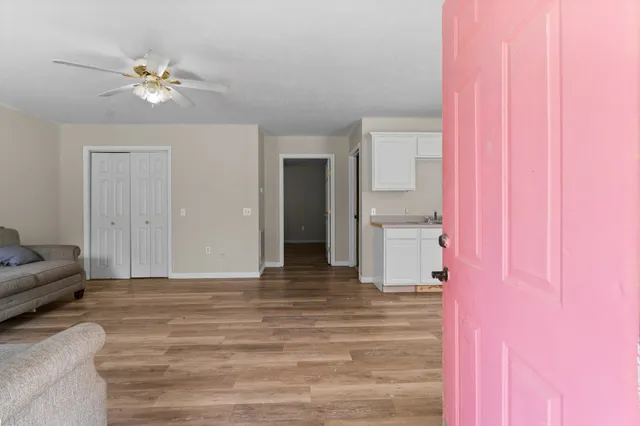 a living room with furniture and a ceiling fan