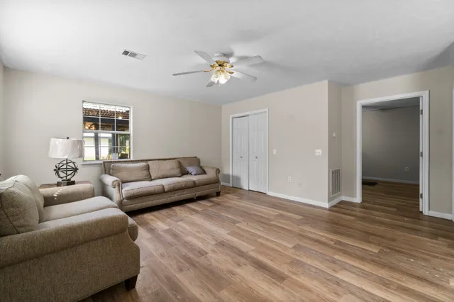 a living room with furniture and a large window