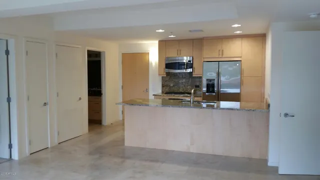 a kitchen with stainless steel appliances a refrigerator and microwave