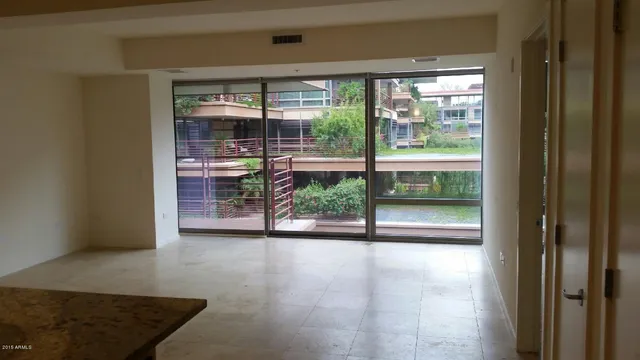 a view of empty room with floor to ceiling window