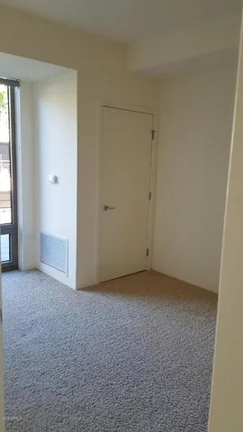 a bathroom with a granite countertop toilet and sink