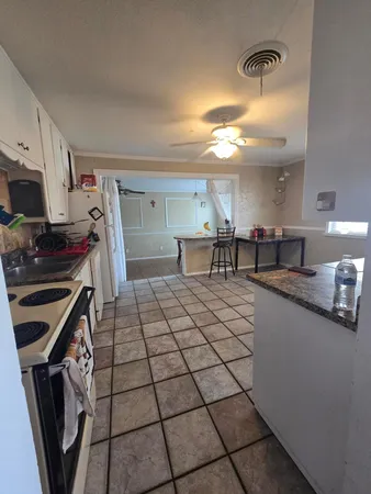 a kitchen with a sink a stove and cabinets