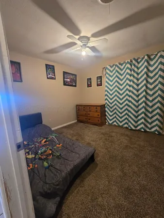 a bed sitting in a room and rug