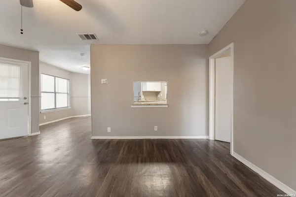 wooden floor in an empty room with a window