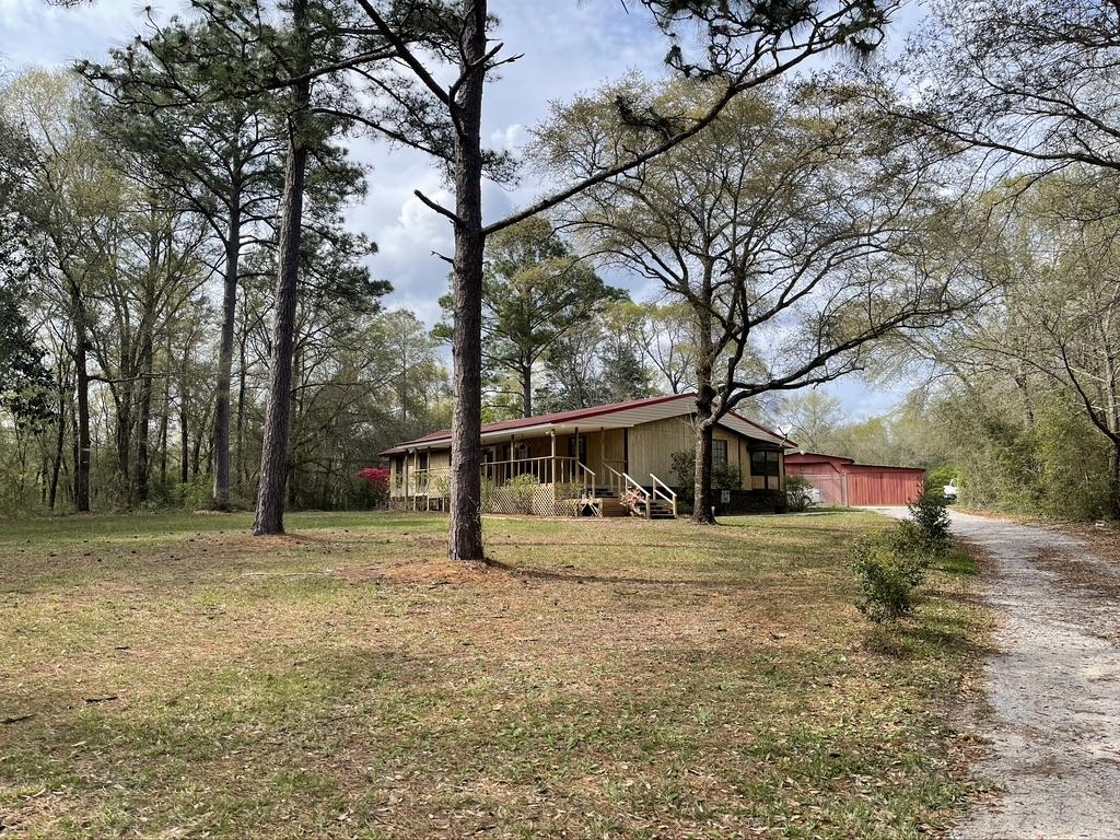 4223 Poverty Creek Road Crestview, FL 32539 - Photo 5 of 27 a view of a yard with large trees