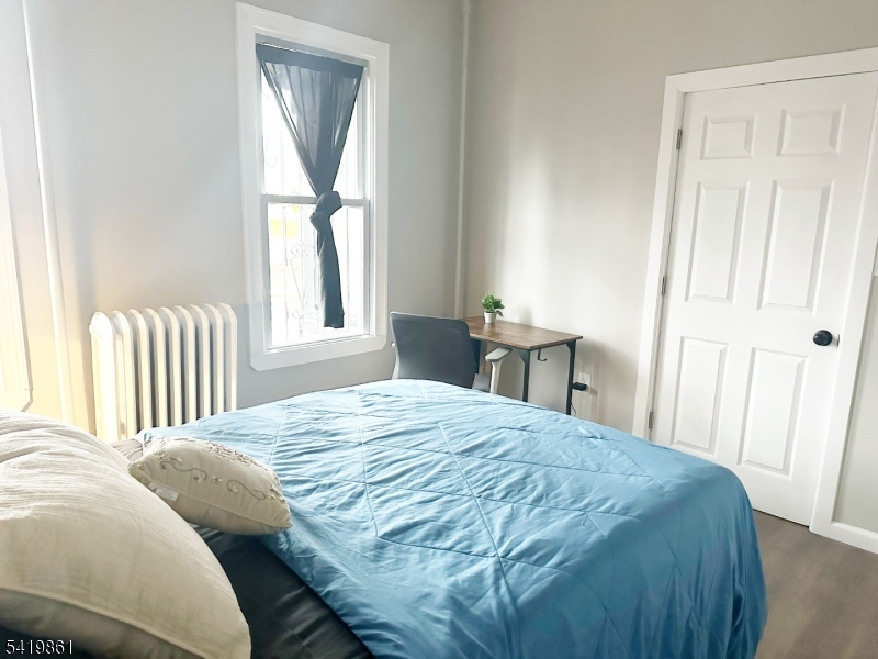 34 Duryea Street Newark, NJ 07103 - Photo 8 of 15 a bedroom with a bed and a window