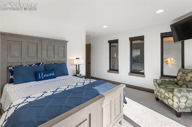 a living room with furniture and large windows