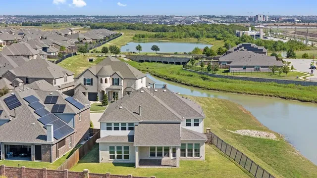 an aerial view of residential houses with outdoor space and seating