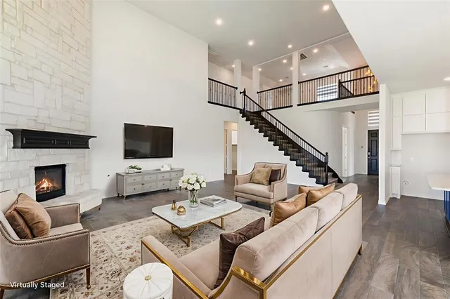 a living room with furniture kitchen view and a flat screen tv