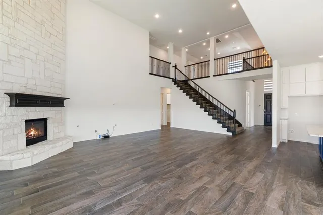 a view of a livingroom with wooden floor and a fireplace