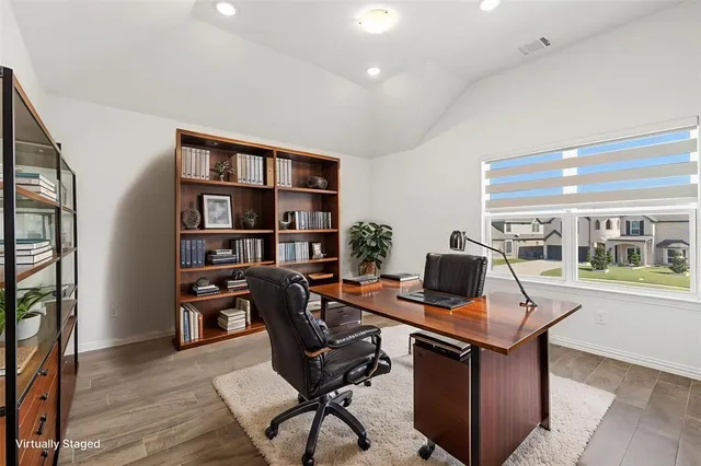 a work room with furniture and a bookshelf